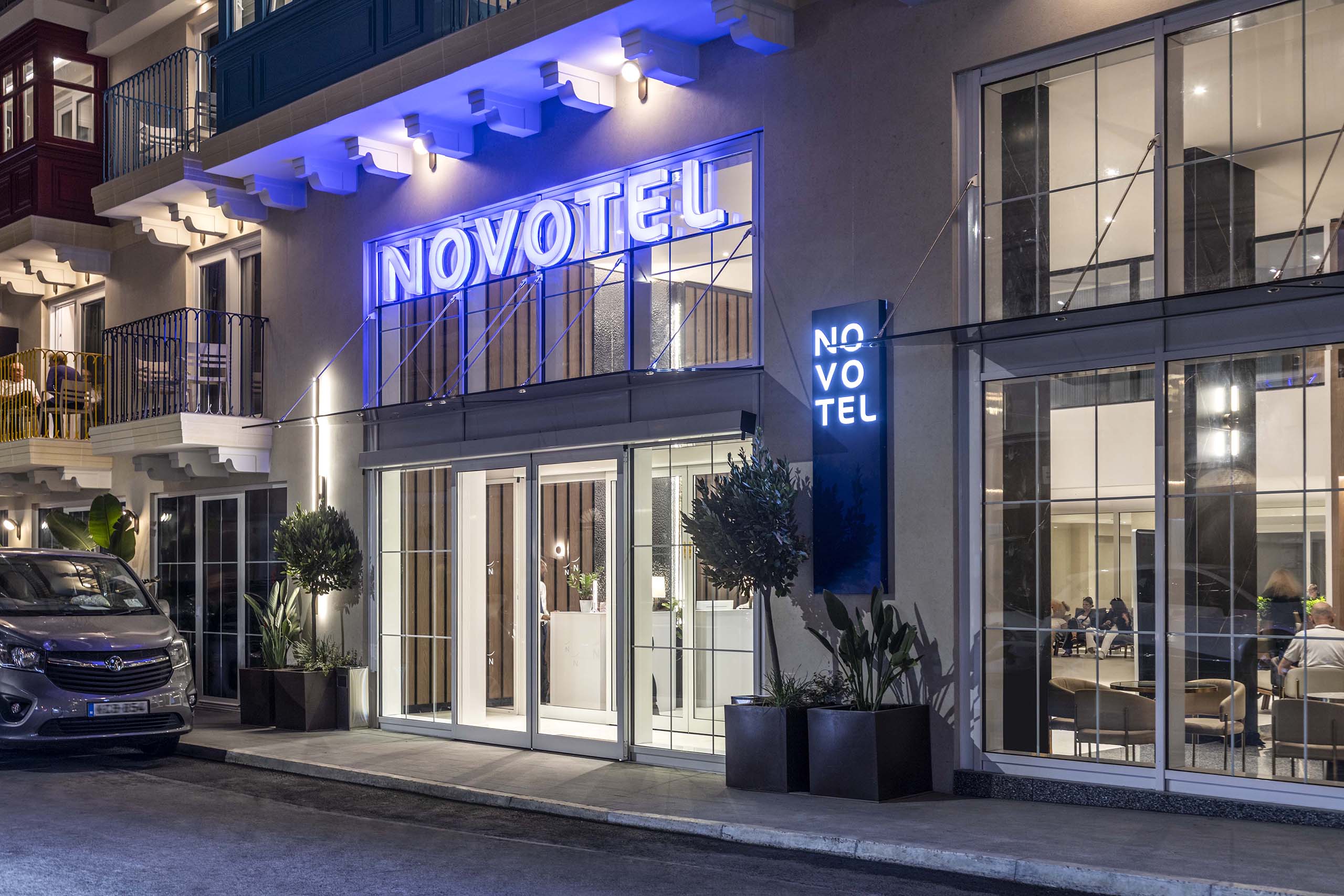 Modern hotel entrance with illuminated signage