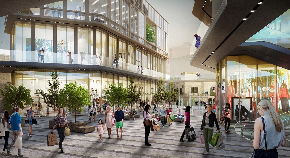 Modern shopping centre with bustling crowds.