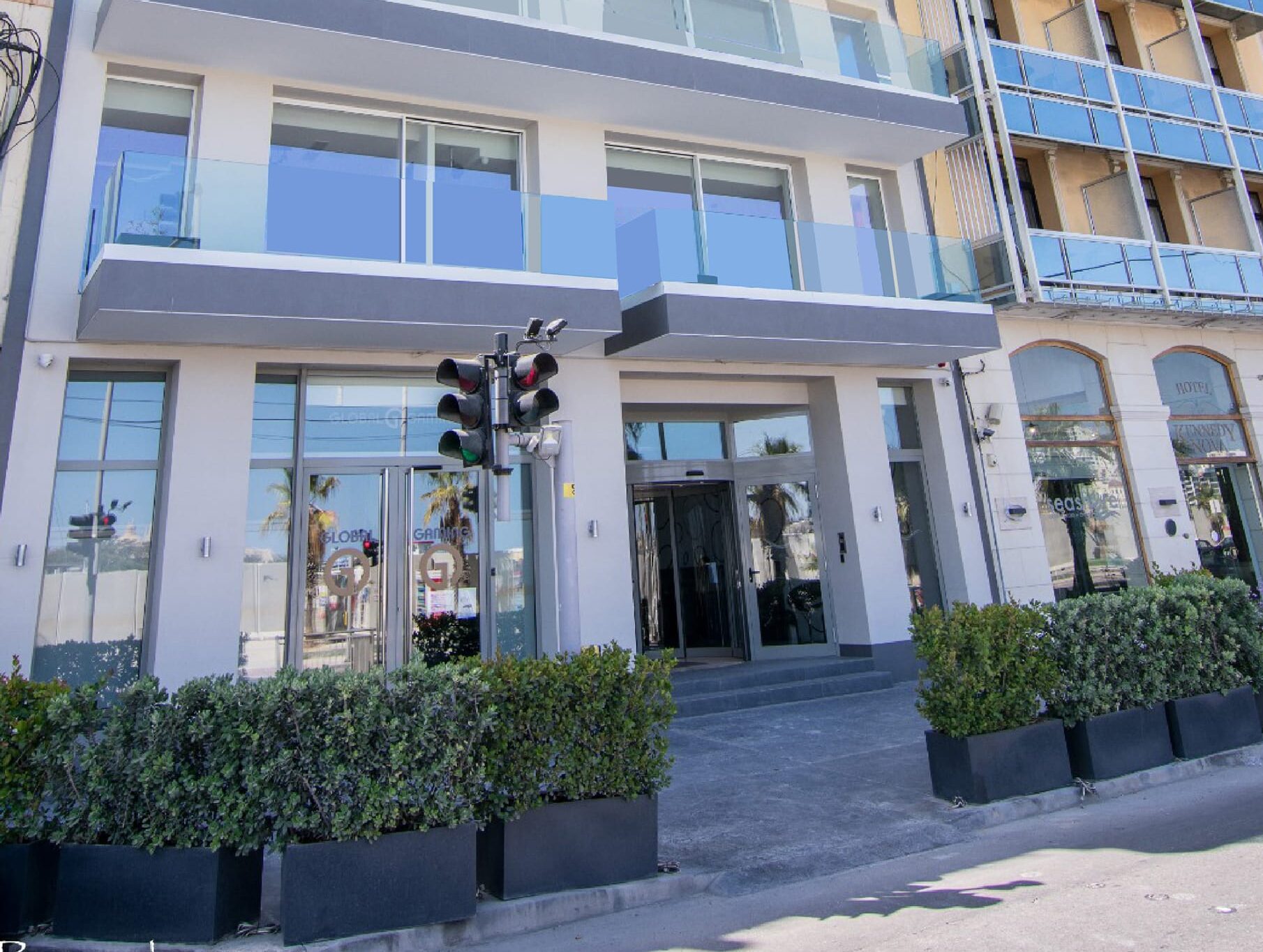 Modern hotel entrance with traffic lights.